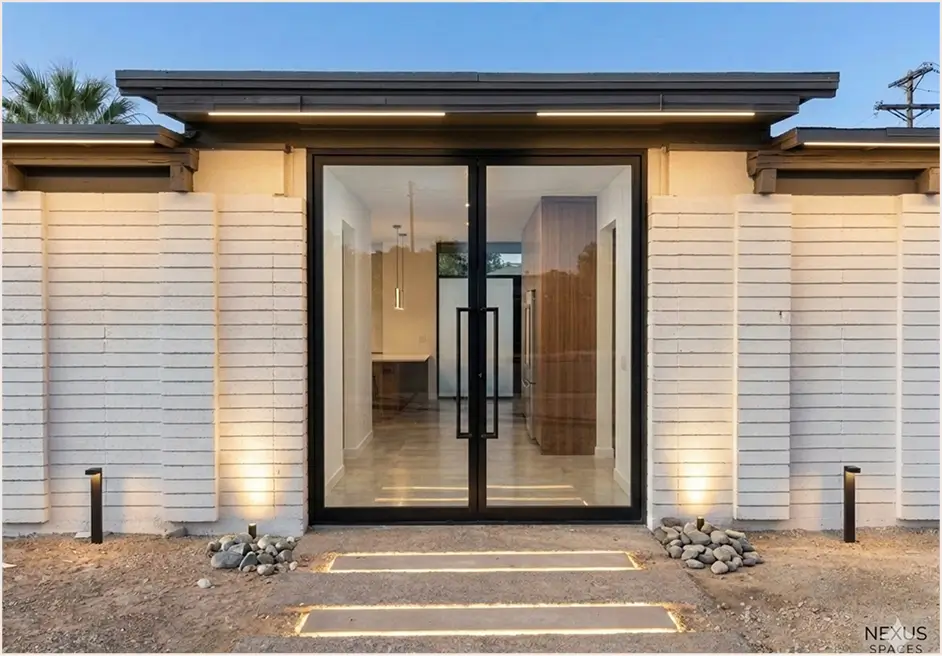 Two-storey home at dusk with glass garage door