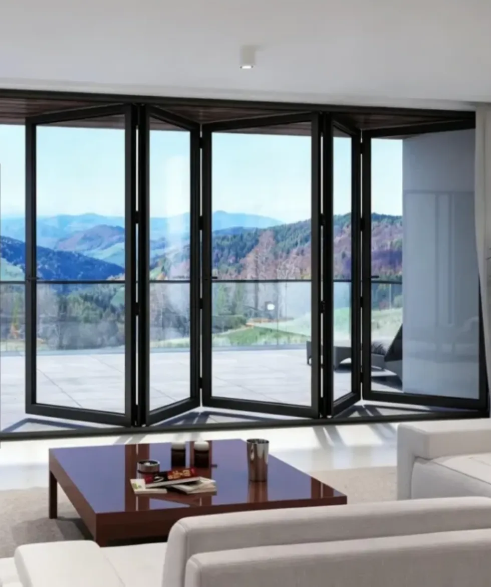 Living room with black-framed folding glass doors and mountain views